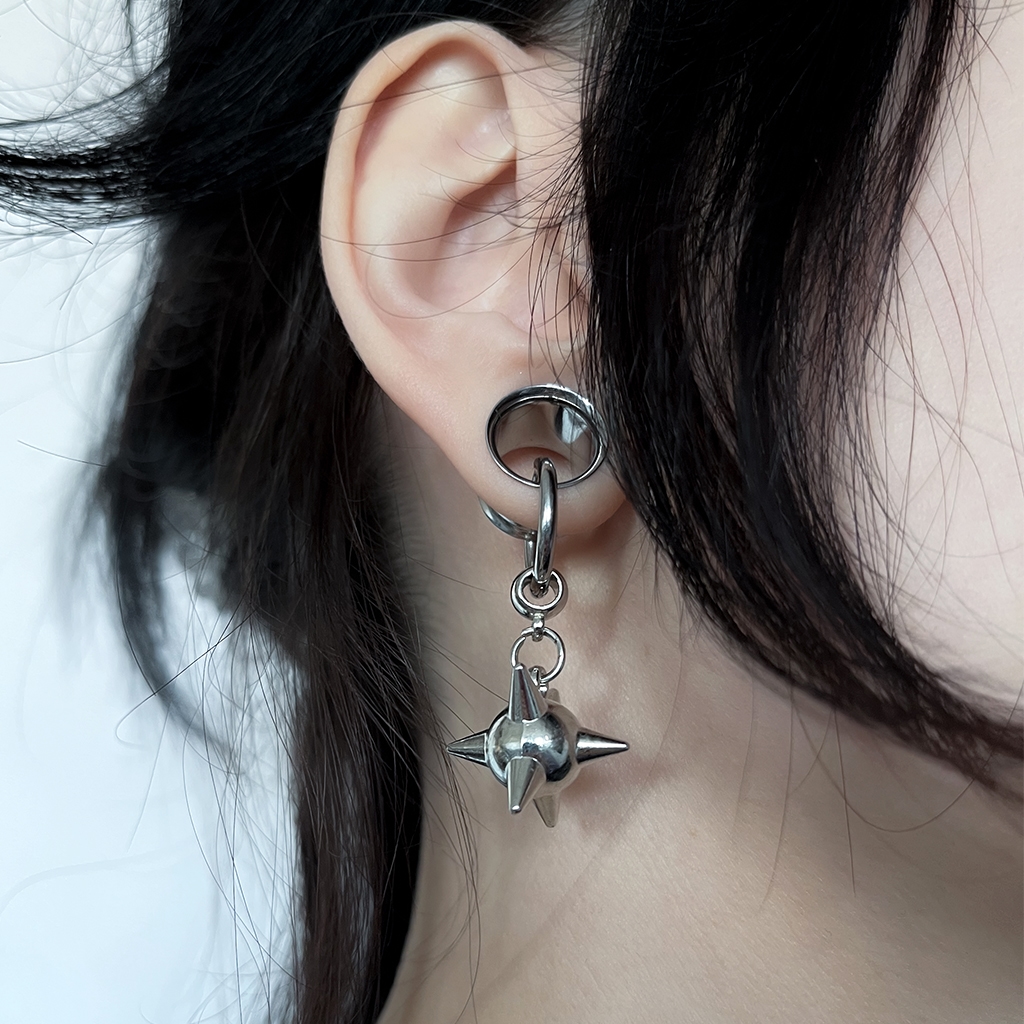 Spike bomb ear tunnel charm earring hanging from ear tunnel